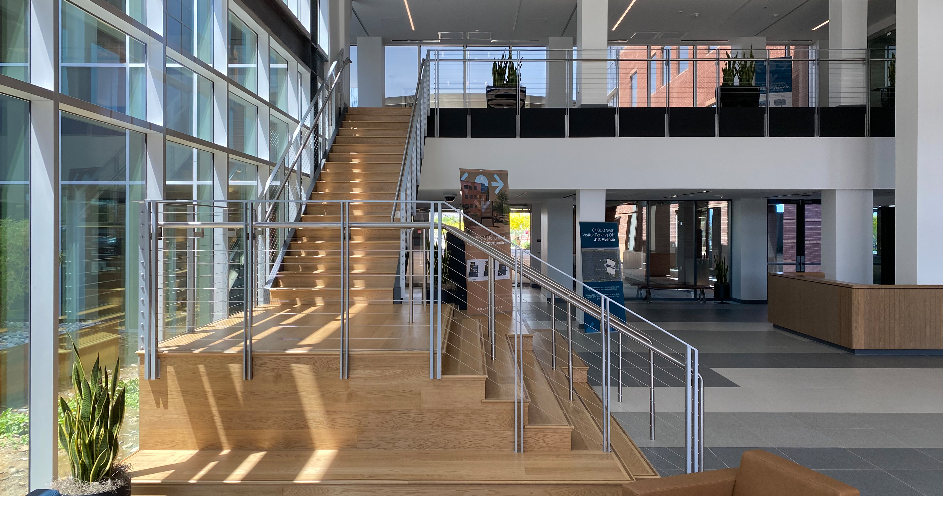 office lobby interior with monumental stair glass facade and natural light Phoenix Arizona