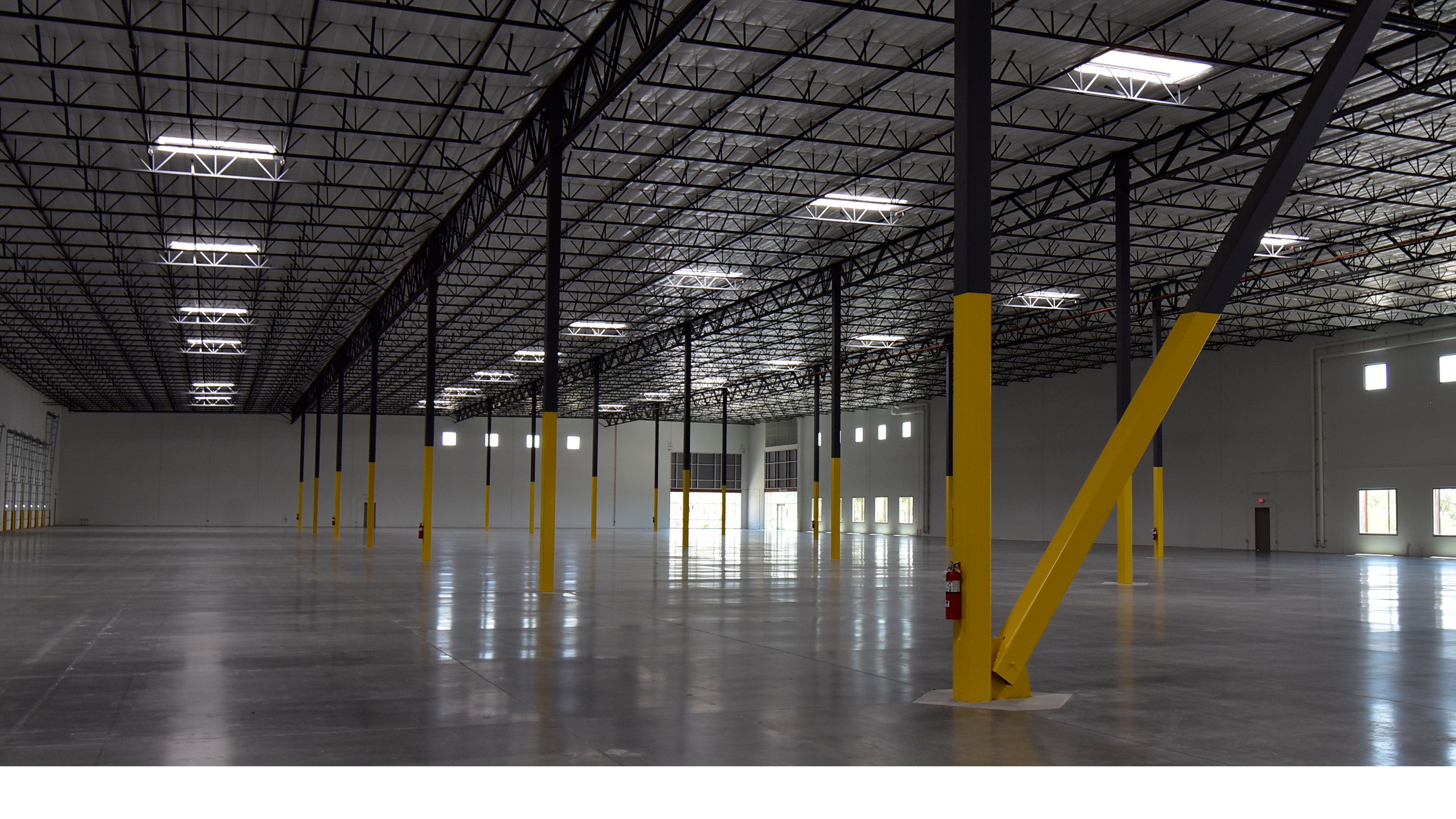 industrial distribution center interior with open floor space structural columns and high bay ceiling Mesa Arizona