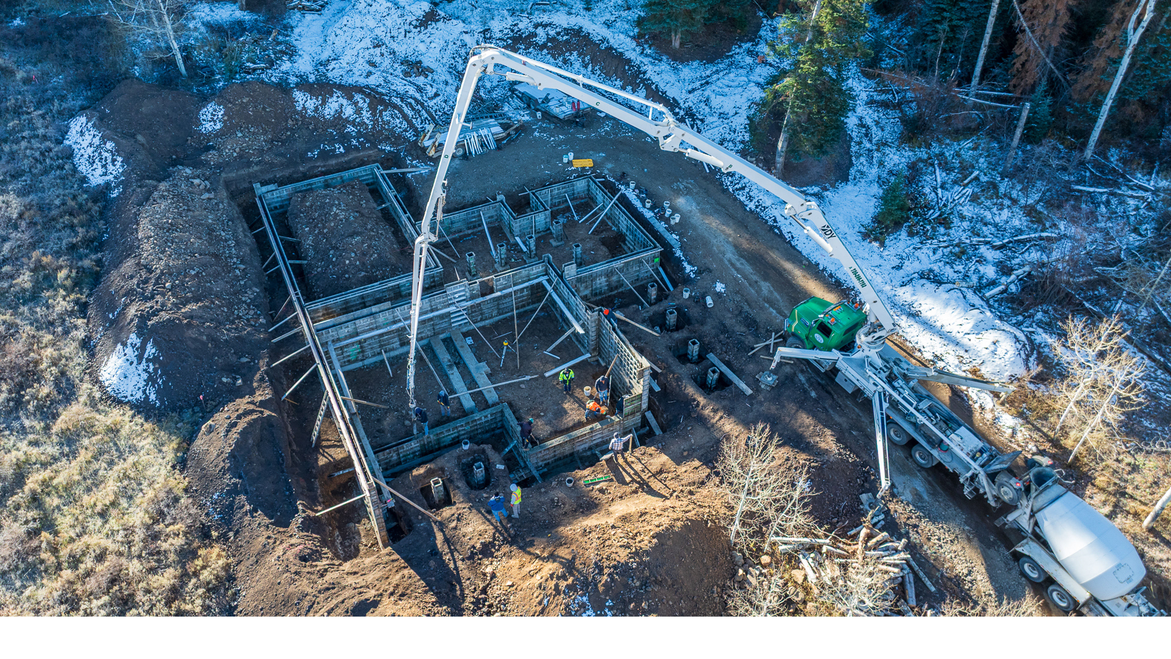 Concrete being pumped into foundation formwork for the Duris Residence in Stagecoach Colorado