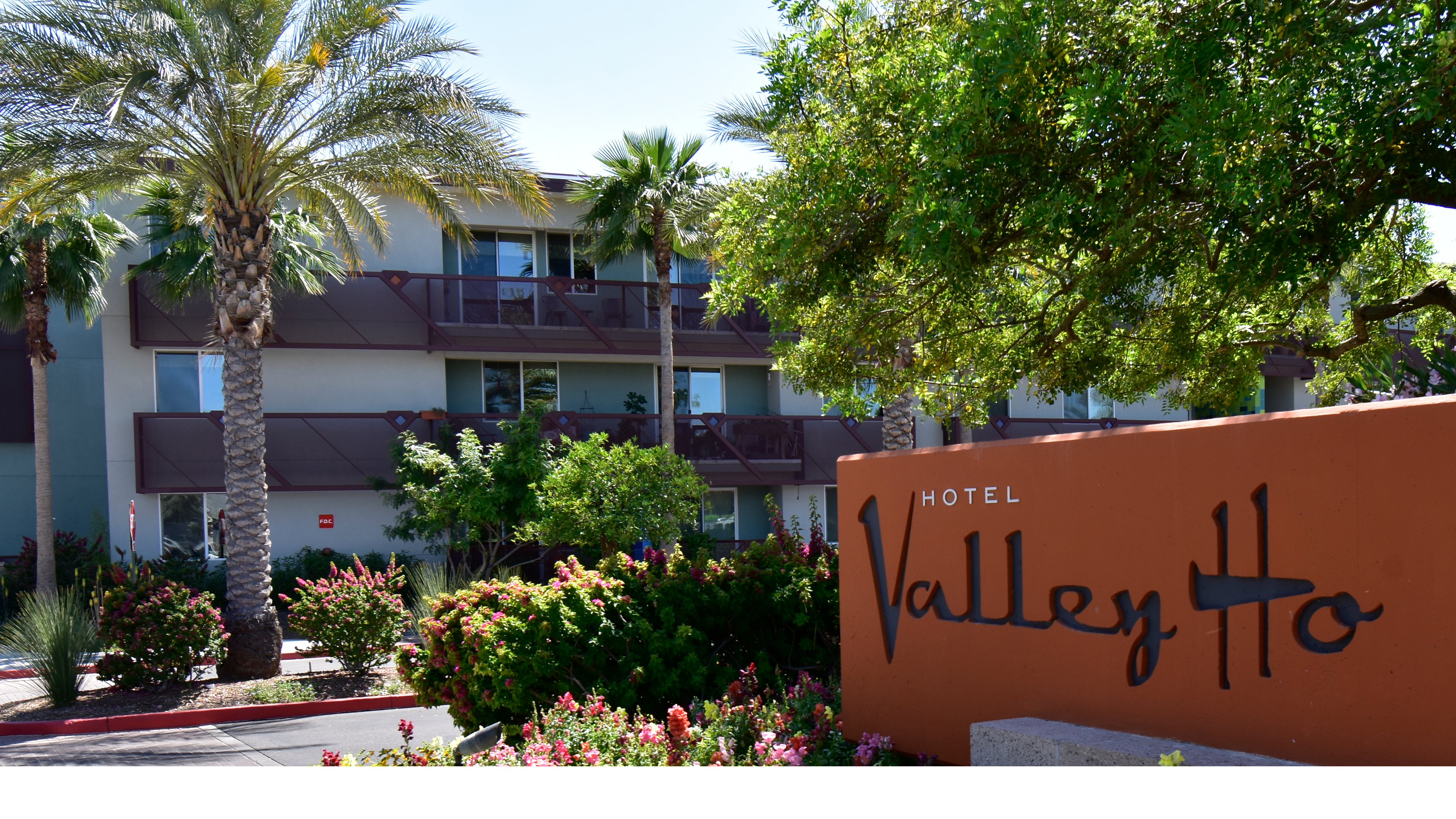 apartment building at Valley Ho Scottsdale Arizona with monument sign landscaping and palm trees