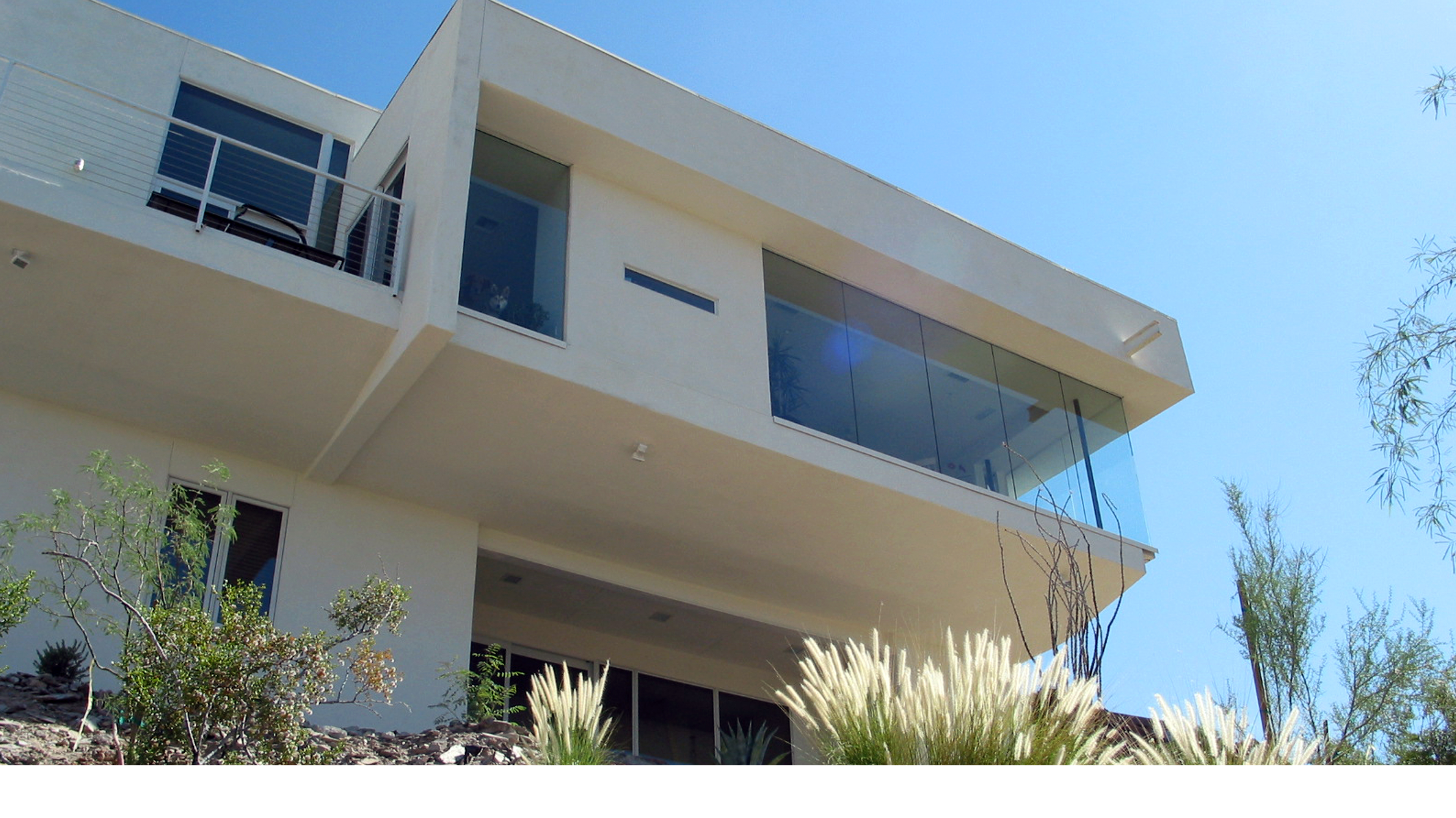 modern minimalist custom home with cantilevered balcony and stucco facade Phoenix Arizona